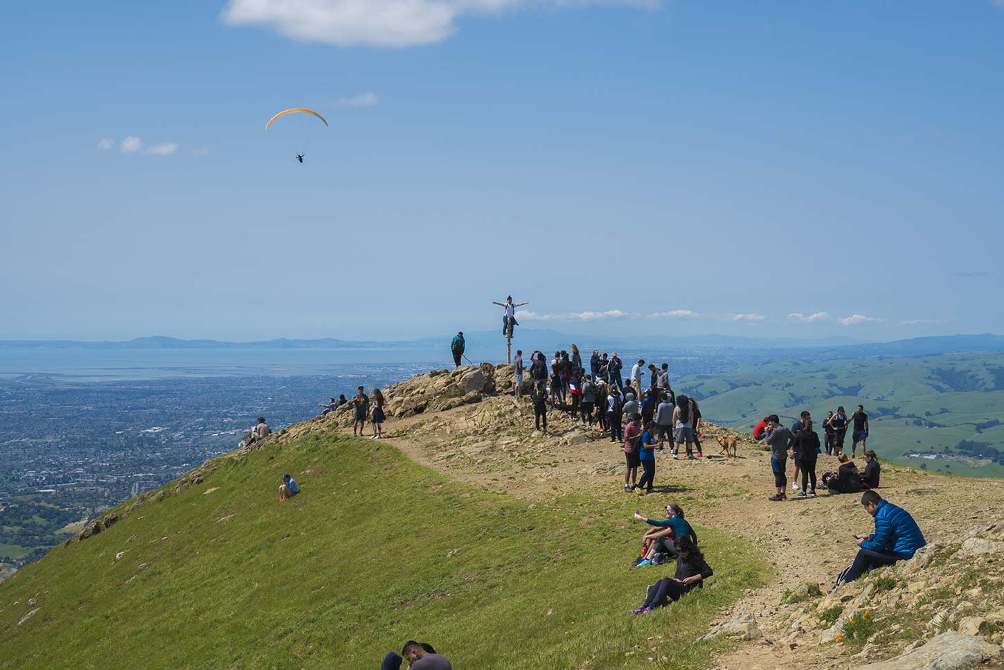Line of hikers waiting to take pictures on Mission Peak